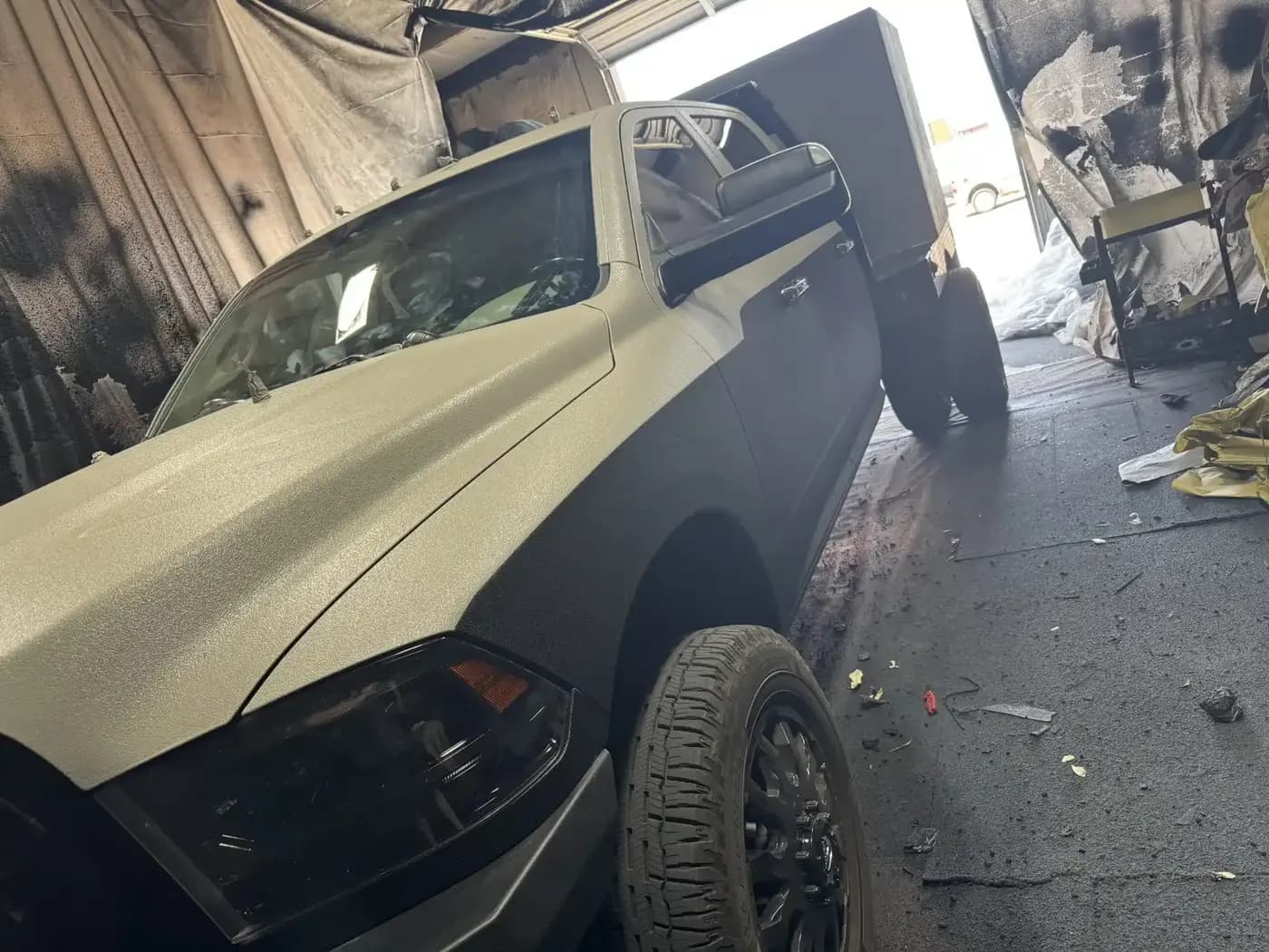 Pickup truck receiving a protective coating in the Truck Gear shop