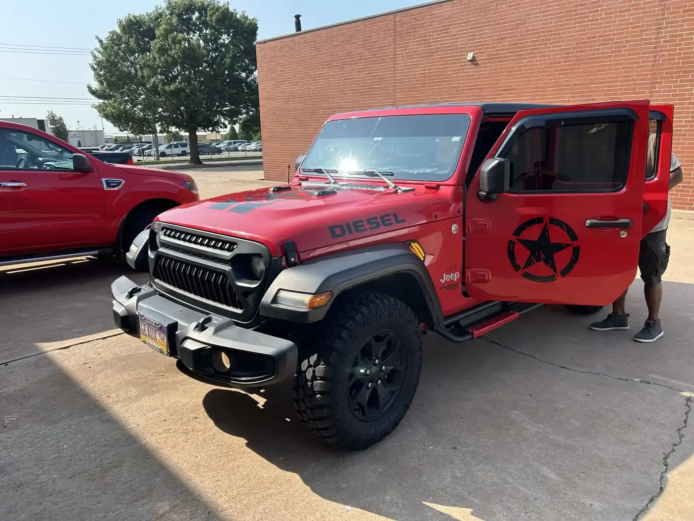 Red Jeep customized with off-road truck accessories